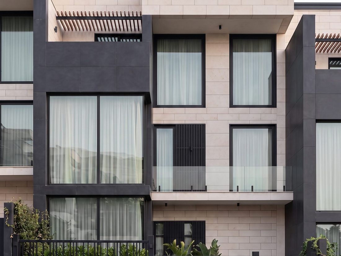 Sky Villas street facade — dark panelling, stone and glass balconies, Bagebi, Vake, Tbilisi