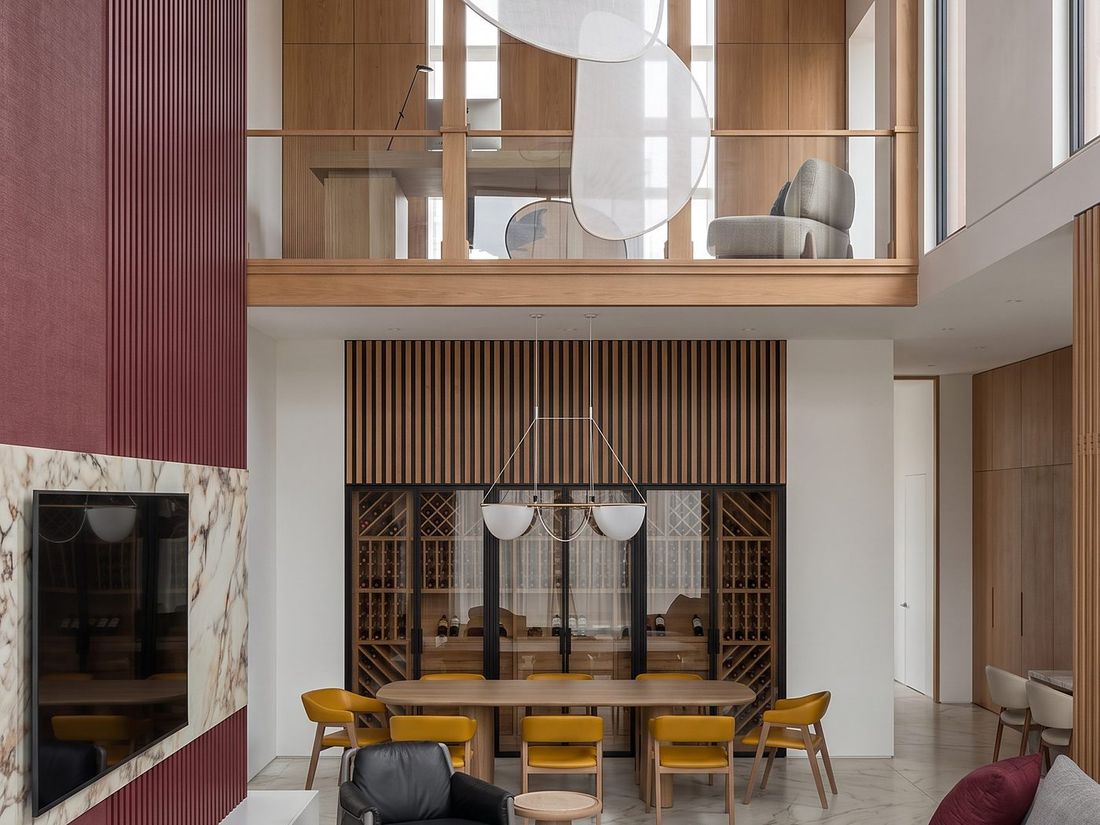 Double-height living and dining room with a marble fireplace, Sky Villas